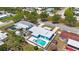 Aerial view of the property featuring a private pool, fenced yard and lush greenery at 3215 58Th N St, St Petersburg, FL 33710
