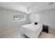 Bedroom featuring a window and ceiling fan, furnished with a simple bed at 3215 58Th N St, St Petersburg, FL 33710