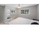 Bedroom with closet with mirrored doors, a ceiling fan, and a window at 3215 58Th N St, St Petersburg, FL 33710
