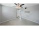 Bedroom with a window and ceiling fan and an open door to the hallway at 3215 58Th N St, St Petersburg, FL 33710