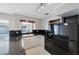 Bright kitchen features white cabinets, black appliances, and sleek black backsplash at 3215 58Th N St, St Petersburg, FL 33710