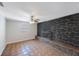 Cozy living room with a stone fireplace, ceiling fan, and neutral decor at 3215 58Th N St, St Petersburg, FL 33710