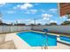 Sparkling in-ground pool with a white fence, perfect for relaxation and recreation at 3215 58Th N St, St Petersburg, FL 33710