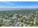 Aerial view of a residential neighborhood with mature trees and the ocean and city in the distance at 356 20Th Ne Ave, St Petersburg, FL 33704