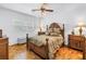 Comfortable bedroom featuring hardwood floors, a ceiling fan, and an accent bed frame at 356 20Th Ne Ave, St Petersburg, FL 33704
