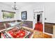 Cozy dining area with glass-top table, decorative rug, and view to staircase and kitchen at 356 20Th Ne Ave, St Petersburg, FL 33704