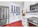 Updated kitchen with stainless steel appliances, white cabinets, and unique tile flooring at 356 20Th Ne Ave, St Petersburg, FL 33704
