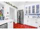 Well-lit kitchen with stainless steel refrigerator, tile flooring, and white cabinetry at 356 20Th Ne Ave, St Petersburg, FL 33704