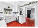 Bright kitchen with white cabinets, modern appliances, and tiled floor, with an adjacent staircase at 356 20Th Ne Ave, St Petersburg, FL 33704