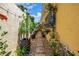 A landscaped path along the side of the home with rock ground covering and container plants at 356 20Th Ne Ave, St Petersburg, FL 33704