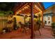 Outdoor patio with pergola, comfortable seating, and lush landscaping at twilight at 356 20Th Ne Ave, St Petersburg, FL 33704