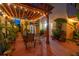 Outdoor patio with pergola, comfortable seating, and lush landscaping at night at 356 20Th Ne Ave, St Petersburg, FL 33704