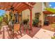 Outdoor patio with a wooden pergola, fan, seating, grill, and potted plants at 356 20Th Ne Ave, St Petersburg, FL 33704