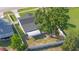 Aerial view of a fenced backyard with a large shade tree and a covered structure at 3709 Danny Bryan Blvd, Tampa, FL 33619