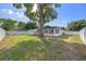 Fenced backyard featuring a mature shade tree and a covered parking structure at 3709 Danny Bryan Blvd, Tampa, FL 33619