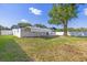 View of backyard featuring large shade tree, carport, and pristine white fence at 3709 Danny Bryan Blvd, Tampa, FL 33619