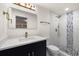 Modern bathroom featuring a navy blue vanity with gold hardware and a walk-in shower with blue mosaic tile accents at 3709 Danny Bryan Blvd, Tampa, FL 33619
