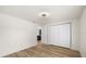 Bedroom featuring wood-look flooring, closet, and connecting door to the kitchen at 3709 Danny Bryan Blvd, Tampa, FL 33619