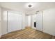 Bedroom with modern lighting, wood-look flooring, and ensuite bathroom through sliding barn door at 3709 Danny Bryan Blvd, Tampa, FL 33619