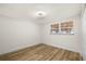 Clean bedroom with wood-look flooring, large window, and ample natural light at 3709 Danny Bryan Blvd, Tampa, FL 33619