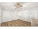 Spacious dining room with hardwood floors, modern lighting, and a doorway leading to another area at 3709 Danny Bryan Blvd, Tampa, FL 33619