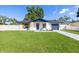 Charming single-story home featuring a well-manicured lawn, fresh exterior paint and inviting curb appeal at 3709 Danny Bryan Blvd, Tampa, FL 33619