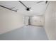 Spacious garage with painted floor, an overhead storage rack, and access to a laundry area at 3709 Danny Bryan Blvd, Tampa, FL 33619