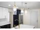Kitchen pendants highlight the navy and white cabinets and spacious countertop at 3709 Danny Bryan Blvd, Tampa, FL 33619