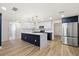 Spacious kitchen featuring an island with white countertops and wood flooring at 3709 Danny Bryan Blvd, Tampa, FL 33619