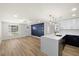 Bright, open-concept living space with modern kitchen, stylish lighting, and wood-look flooring at 3709 Danny Bryan Blvd, Tampa, FL 33619