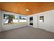 Charming sunroom with wood-paneled ceiling, block walls, and backyard access at 3709 Danny Bryan Blvd, Tampa, FL 33619