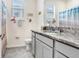 Bright bathroom with granite countertops, decorative wall art, and a shower-tub combo at 3719 Stormy Thistle Pl, Plant City, FL 33565