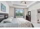 Bright bedroom with a tray ceiling, large window with backyard views, and neutral carpeting at 3719 Stormy Thistle Pl, Plant City, FL 33565