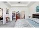 Bedroom with tray ceiling and views of the walk-in closet and ensuite bathroom at 3719 Stormy Thistle Pl, Plant City, FL 33565