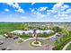 Aerial view of a well-maintained clubhouse with ample parking and green surroundings at 3719 Stormy Thistle Pl, Plant City, FL 33565