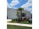 Well-maintained home featuring a palm tree, fresh landscaping, and an attached two car garage at 3719 Stormy Thistle Pl, Plant City, FL 33565