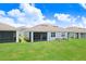 Beautiful back exterior featuring a well-maintained lawn and screened-in patio at 3719 Stormy Thistle Pl, Plant City, FL 33565