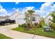 Charming single-story home with a well-manicured lawn, a two car garage, and a beautiful palm tree at 3719 Stormy Thistle Pl, Plant City, FL 33565