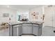 Open-concept kitchen with granite counters, stainless steel appliances, and an island with seating at 3719 Stormy Thistle Pl, Plant City, FL 33565