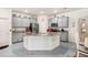 Spacious kitchen boasts modern gray cabinets, an island, stainless steel appliances, and recessed lighting at 3719 Stormy Thistle Pl, Plant City, FL 33565
