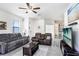Inviting living room featuring tile floors, a ceiling fan, comfortable seating, and a view into the kitchen at 3719 Stormy Thistle Pl, Plant City, FL 33565