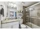 Bathroom with vanity, granite countertop, glass-enclosed shower, and ample storage at 4017 Cedar Limb Ct, Tampa, FL 33614