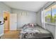 Cozy bedroom with natural light, laminate floors, a window view, and neutral wall color at 4017 Cedar Limb Ct, Tampa, FL 33614