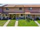Charming townhome with manicured lawn, walkway, and cozy front patio area showcasing curb appeal at 4017 Cedar Limb Ct, Tampa, FL 33614