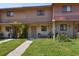 Charming townhouse showcasing a cozy porch and well-maintained front lawn at 4017 Cedar Limb Ct, Tampa, FL 33614