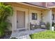 Welcoming front porch with stylish seating and lush landscaping, enhancing the home's exterior at 4017 Cedar Limb Ct, Tampa, FL 33614