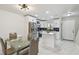 Bright kitchen with stainless steel appliances, white cabinets, and dining table at 4017 Cedar Limb Ct, Tampa, FL 33614