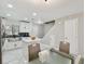 Modern eat-in kitchen featuring white cabinets, stainless steel appliances and a center island at 4017 Cedar Limb Ct, Tampa, FL 33614