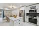 Modern kitchen, dining and living area featuring an island and stainless steel appliances at 4017 Cedar Limb Ct, Tampa, FL 33614
