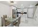 Modern kitchen with white cabinets, stainless steel appliances, a peninsula, and elegant marble tile flooring at 4017 Cedar Limb Ct, Tampa, FL 33614